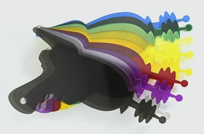 Image of multiple cartoon-style laser gun parts cut out of various colors of acrylic