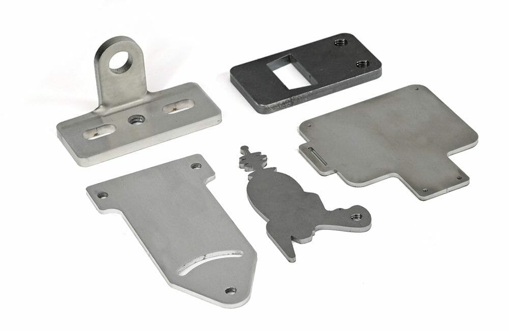 Image of 5 tapped parts made from materials that are currently available for our sheet metal tapping service