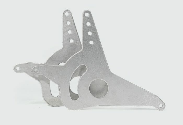 Image of laser cut 6061 aluminum parts on a white background