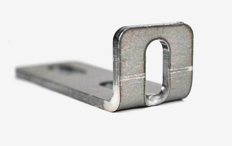 A bent sheet metal part with an oblong hole crossing the bend line. The hole is warped because it's too close to the bend