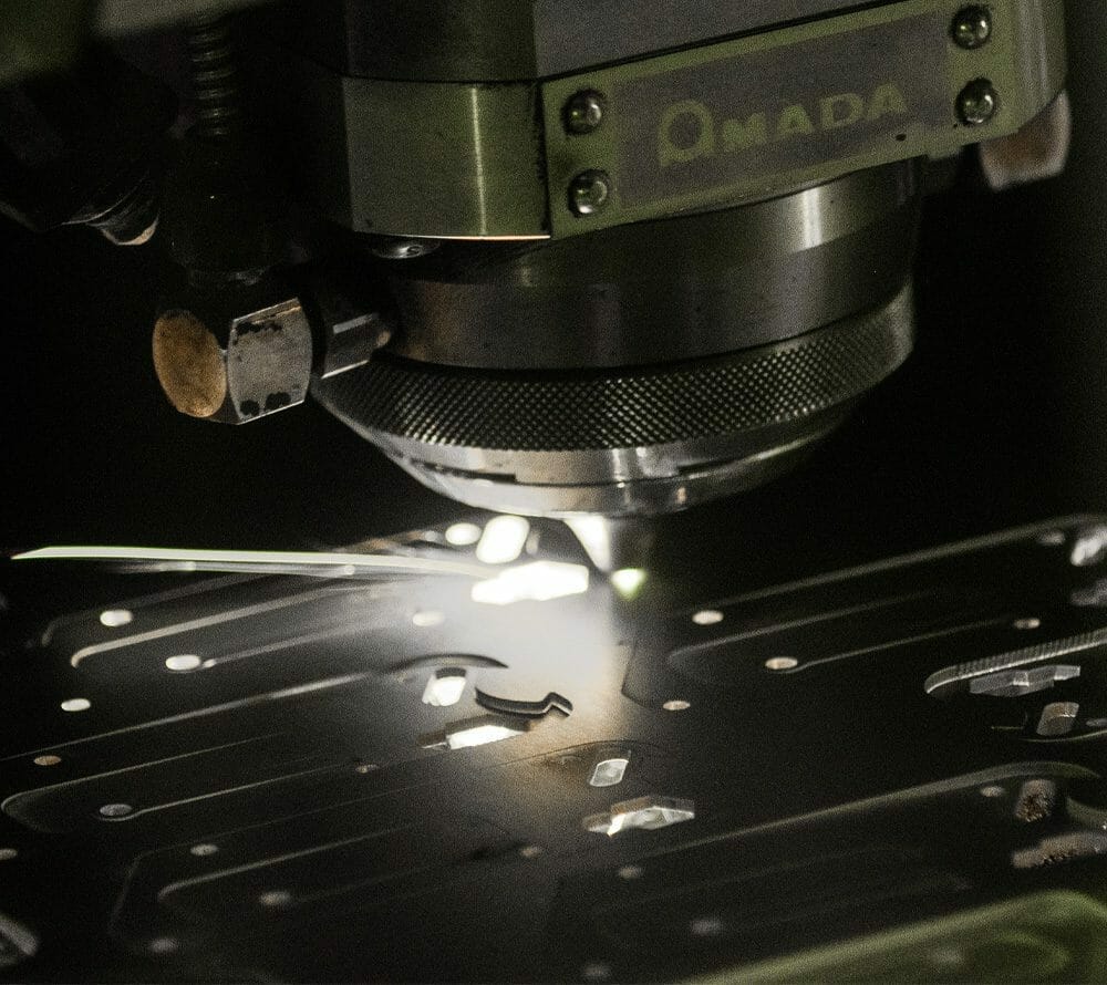 Closeup image of an Amada laser cutter to show the capabilities of laser cutting