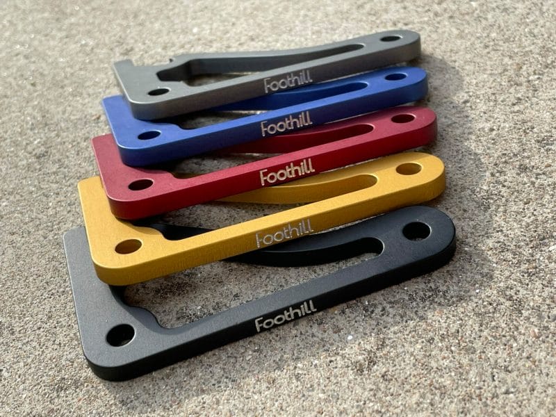 5 anodized aluminum bottle levers from Foothill Products in gray, blue, red, yellow, and black, with the Foothill logo etched on the side.