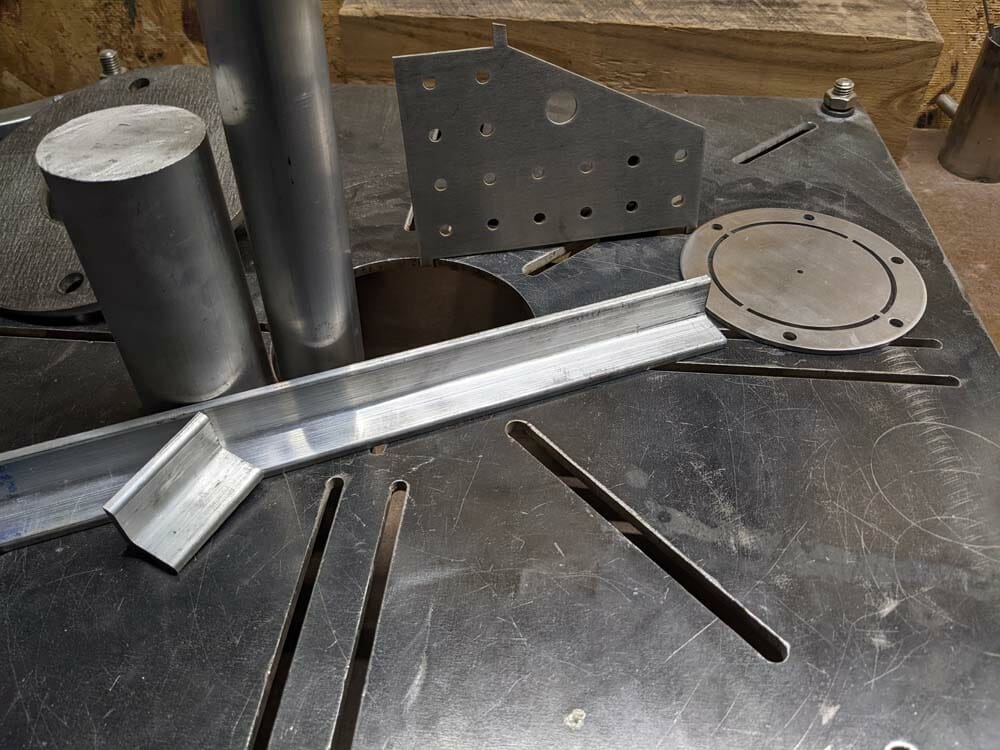 Image of an assortment of laser cut and waterjet cut parts in various materials suited for welding.