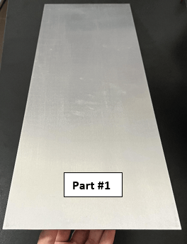 Image of a flat sheet of aluminum with no bends and text that reads "Part #1"