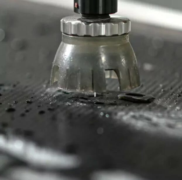 Close up of SendCutSend waterjet cutting machine