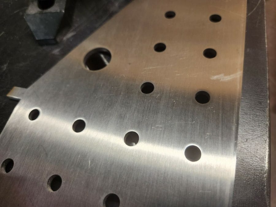 304 stainless part with ¼” holes after being deburred.