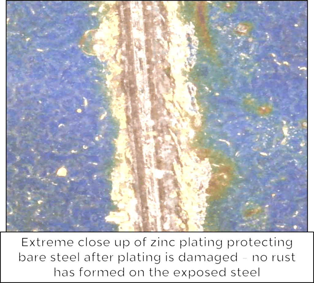 extreme close up of zinc plating protecting bare steel after plating is damaged 