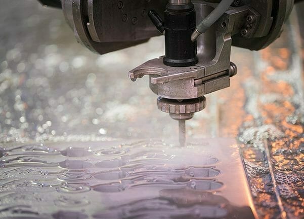 a close up of the sendcutsend waterjet cutting process