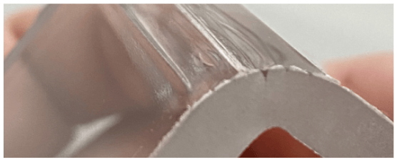 Bent polycarbonate part with surface cracks